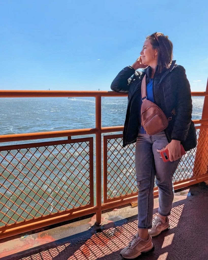 Woman staring at the sea while riding the Staten Island Ferry. 