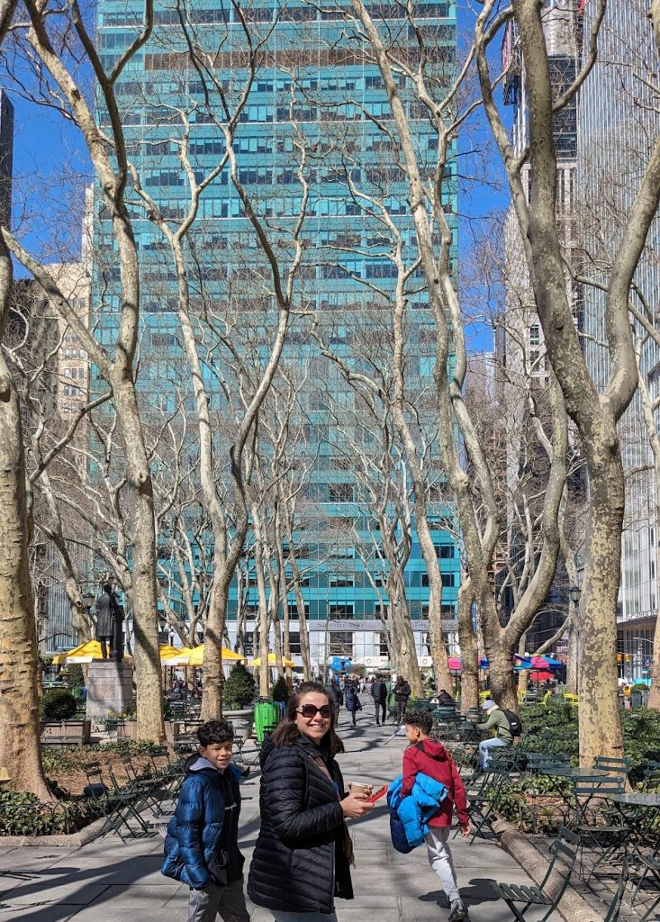 Mom and two kids walking through Bryant Park in New York City. 