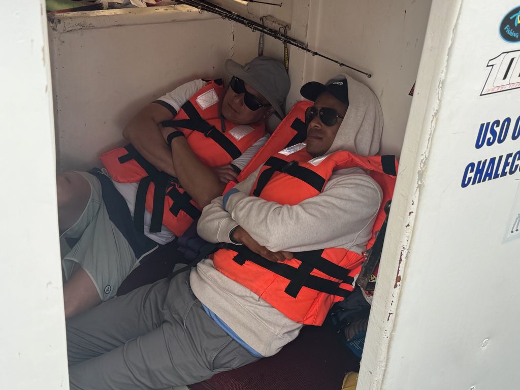Author and friend sleeping in boat deck after getting seasick. 